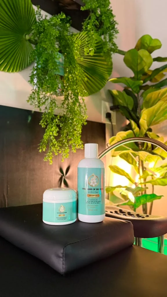 The Rose of Sharon shampoo and treatment on a table in the studio, among the plants